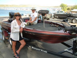 Peggy Harrell and Mark Nesbit and their bass boat at Navajo Lake, New Mexico.