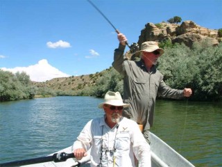 Larry Johnson mans the oars of his drift boat while Tim McCarthy casts during a recent trip down the lower San Juan River.