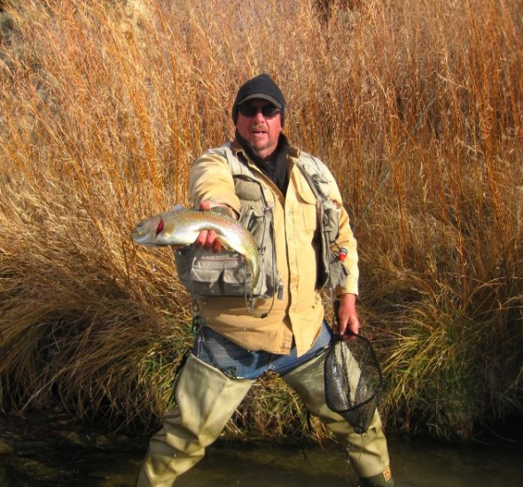 The author shows off a typical San Juan River Rainbow trout.