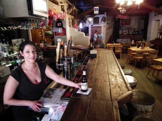 A pretty bartender at Los Ojos Bar in Jemez Springs serves up a cold Coors. 