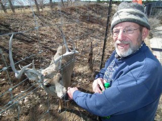 Founder and Executive Director, Roger Alink, visits with Lucky the Deer at Wildlife West Nature Park in Edgewood, New Mexico.