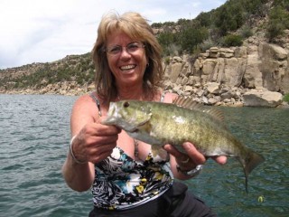 Peggy Harrell shows off a nice Smallmouth Bass from Navajo Lake.