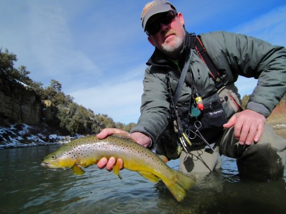 Toner Mitchell poses with brown trout caught in the Chama River of  northern New Mexico.