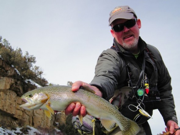 An angler shows off a fat rainbow trout caught while winter fishing on the Rio Chama in northern New Mexico.