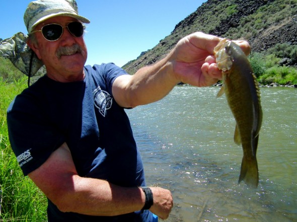 Pojoaque Middle School Shop Teacher, Charlie Harrison, shows off the small mouth bass he caught  during a Project Wild Training Seminar on the Rio Grande in June 2012.