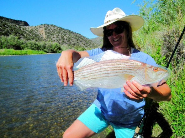 Kirtland Central High School Teacher, Sonnin Dahl, poses with one of plastic fish used in the Project Wild program to familiarize participants with the many aquatic species found in New Mexico.