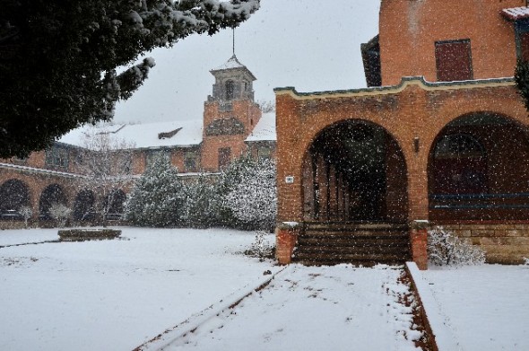 A spring snow storm leaves a dusting on  the Castenada Hotel in Las Vegas NM.