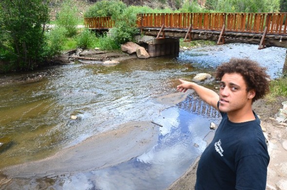 Josh Ingersol, Assistant manager at the Brush Ranch points out how sand filled in what had been the resort's premier fishing hole.