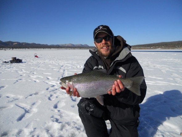 Matt Pelletier of Fish Enchantment shows off a nice trout caught while ice fishing in New Mexico.