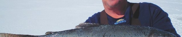 Mitch Roggy, 53, of Albuquerque shows off a nice, fat Rainbow trout he picked up while ice fishing at Eagle Nest Lake one past winter.