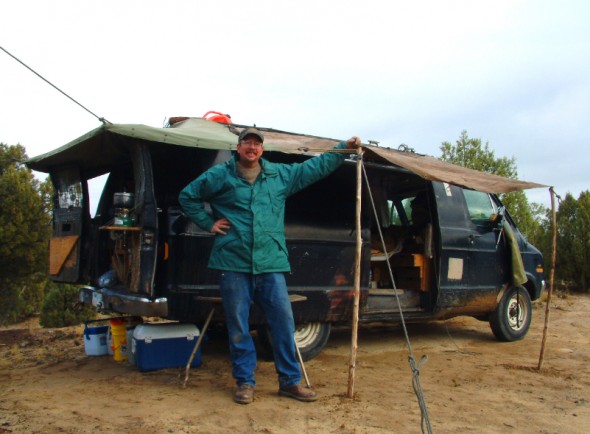 Man poses by camping van 