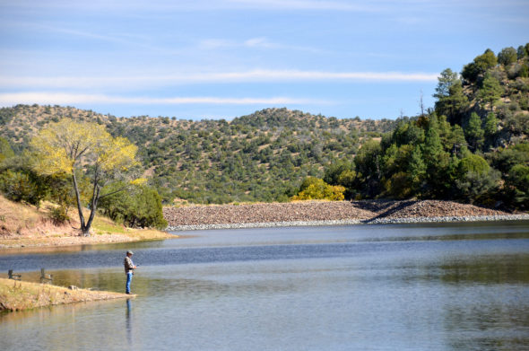 Man fishing at Bear Canyon reservoir in New Mexico 